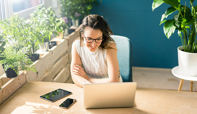 Woman looking out at her devives that are enabled with identify theft protection