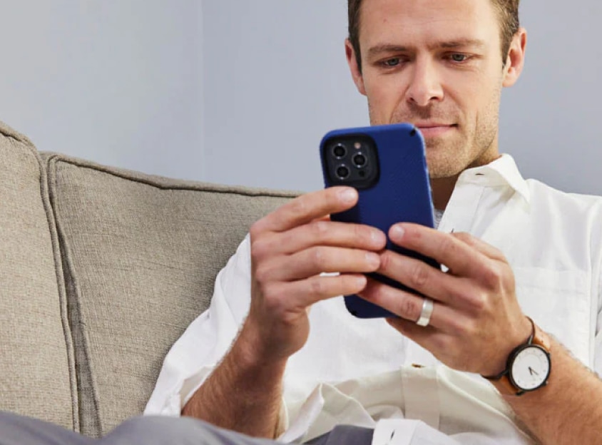 Man on couch looking at phone
